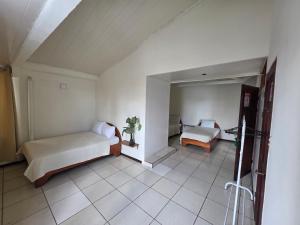 a bedroom with a bed and a couch in a room at Fortuna garden hotel in Fortuna