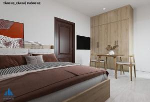 a bedroom with a large bed and a table at Mây Home Hoa Lư in Phúc Trì