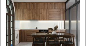 a kitchen with wooden cabinets and a table with chairs at Mây Home Hoa Lư in Phúc Trì