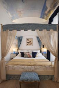 a bedroom with a large bed with a canopy at Bed&Breakfast Andio in Dubrovnik