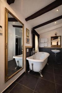 a bathroom with a tub and a sink and a mirror at Bed&Breakfast Andio in Dubrovnik +56 photos