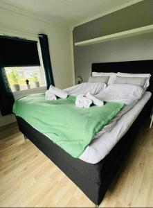 a large bed with two towels on top of it at Sivi`s hus in Moskenes