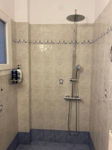 a bathroom with a shower with a glass door at Casa Valeri I - Charming Cycladic Studio in Naxos Town in Naxos Chora