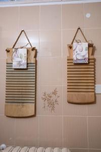 three towels are hanging on a wall in a bathroom at Il trullo di Memarì in La Correggia +17 photos