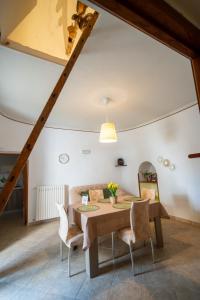 a dining room with a table and chairs at Il trullo di Memarì in La Correggia