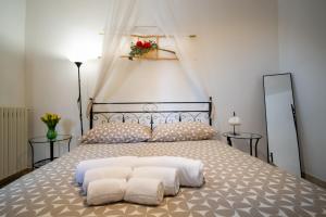 a bedroom with a large bed with two pillows at Il trullo di Memarì in La Correggia