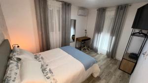 a bedroom with a bed in a room with windows at Villamadrid Home in Madrid