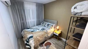 a small bedroom with a bed and a window at Villamadrid Home in Madrid