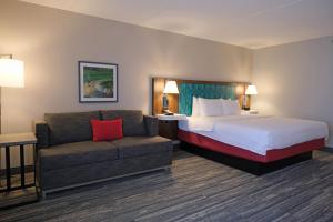 a hotel room with a bed and a couch at Hampton Inn Lima in Lima +17 photos
