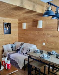 a living room with a couch and a table at Douce Altitudes Cauterets in Cauterets