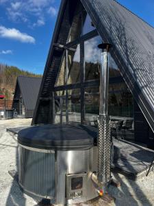 a large boiler in front of a building at A-frame Boema in Cîmpu lui Neag