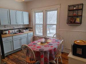 a kitchen with a table with a tablecloth on it at Nigam's Sweet Home in Saint John