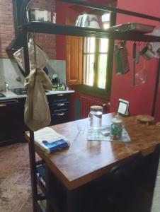 a kitchen with a wooden table and a bunk bed at Villa Paradiso Julia in Dicomano +65 photos