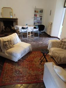 a living room with a table and a white couch at Villa Paradiso Julia in Dicomano