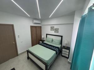 a small bedroom with a bed and a bed sidx sidx sidx at The Perfect Place to be in Boca Chica