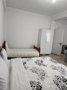 a white bedroom with a bed and a couch at Villa71 in Pogradec +10 photos
