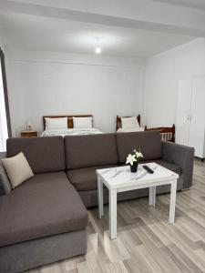 a living room with a couch and a table at Villa71 in Pogradec