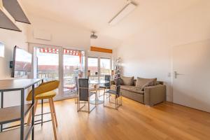 a living room with a couch and a table at Stylish Loft Apartment with Designer Bathroom & Balcony in Berlin