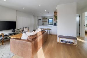 a living room with a couch and a table at Spacious 2BR Retreat, Scenic Views, Modern & New in Whistler +19 photos