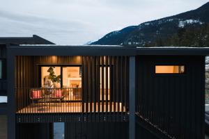 a house with a balcony with a view at Spacious 2BR Retreat, Scenic Views, Modern & New in Whistler