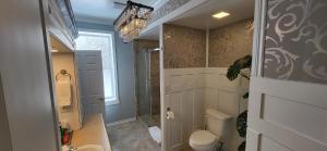 a bathroom with a shower and a toilet and a sink at The Tamworth Hotel, Tamworth ,Ontario, Canada in Tamworth +131 photos