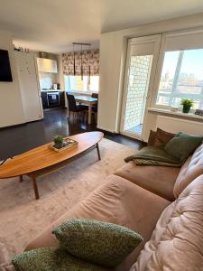 a living room with a couch and a table at Birštonas Relax Apartment in Birštonas