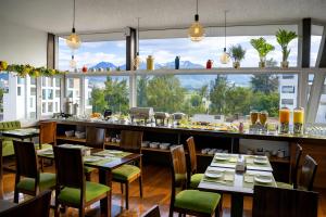 a restaurant with tables and chairs and a large window at Mint Hotel in Arequipa