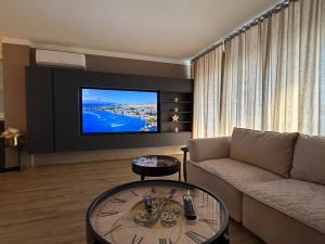 a living room with a couch and a flat screen tv at Bella Mela 2 in Tuzla