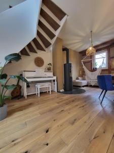 a living room with wood floors and a hammock at Kleine Oase in Ettenheim