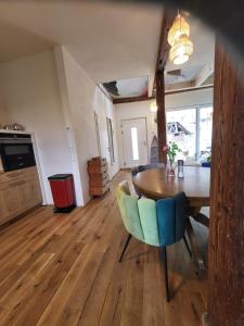 a dining room with a wooden table and chairs at Kleine Oase in Ettenheim +22 photos