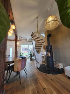 a living room with a fireplace and a hammock at Kleine Oase in Ettenheim