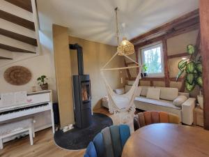a living room with a fireplace and a hammock at Kleine Oase in Ettenheim