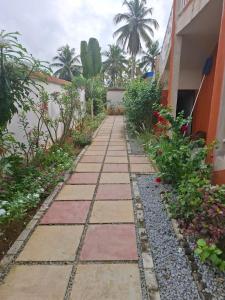 a walkway in front of a building with plants at Complexe Hôtelier Lassavane in Jacqueville