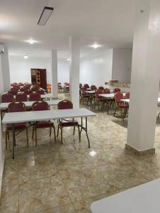 a conference room with tables and chairs in it at Complexe Hôtelier Lassavane in Jacqueville