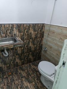 a bathroom with a toilet and a sink at Green Pod 2 - Surigao City in Surigao