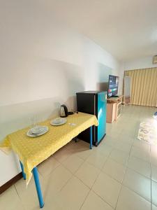 a table with two plates on it in a room at Bts studio rooms in Bangna +3 photos