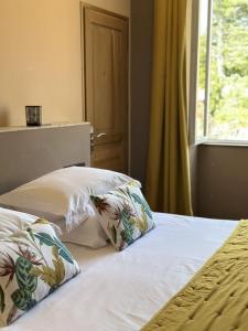 a bedroom with two beds with pillows and a window at La Bastide de Vallon in Vallon-Pont-dʼArc +44 photos