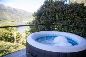 a large jacuzzi tub with snow in it at Altavista Tinyhouse in Macanal +48 photos