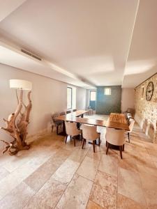 a large dining room with a table and chairs at La Bastide de Vallon in Vallon-Pont-dʼArc