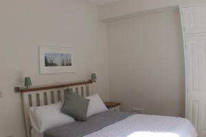 a bedroom with a bed and a picture on the wall at Stunning Seafront Apartment in Aberystwyth