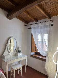 a dressing table with a mirror and a window at L'Orto di Scarpaccia in Pratovecchio +18 photos