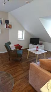 a living room with a couch and a table at Ferienappartements Schweizer Haus in Stolpe