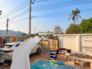 a playground with a slide and a swimming pool at Konijiwa Bangsaen Private Pool Karaoke BBQ in Ban Muang (1)