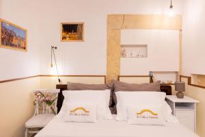 a room with a bed with white sheets and pillows at La Culla di Adeodata in Marsala