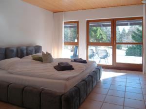a large bed in a room with a large window at Ferienhaus 76 in Freudenstadt