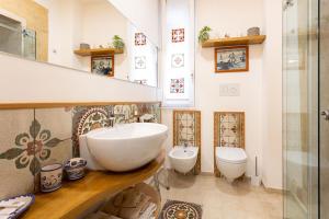 a bathroom with a sink and a toilet at La Culla di Adeodata in Marsala +73 photos