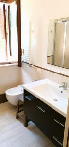 a bathroom with a sink and a tub and a mirror at Residenza Zuc in San Vito lo Capo +11 photos