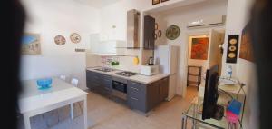 a kitchen with a stove and a refrigerator at Residenza Zuc in San Vito lo Capo