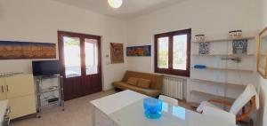 a living room with a couch and a table at Residenza Zuc in San Vito lo Capo