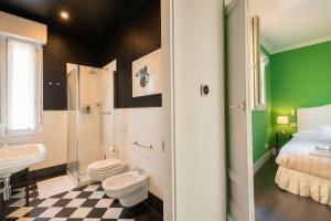 a bathroom with a sink toilet and a shower at Green House Historic Centre in Bologna +24 photos
